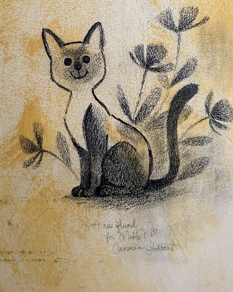 A smiling cat among flowers, drawn in pencil on a yellow wall
