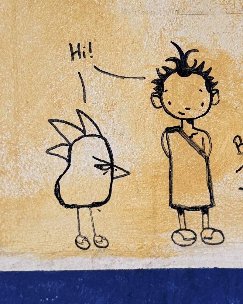 Two small ink figures greeting each other above a band of blue paint